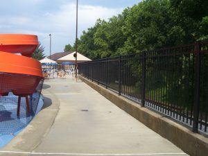 large aluminum pool fence surrounding a community pool