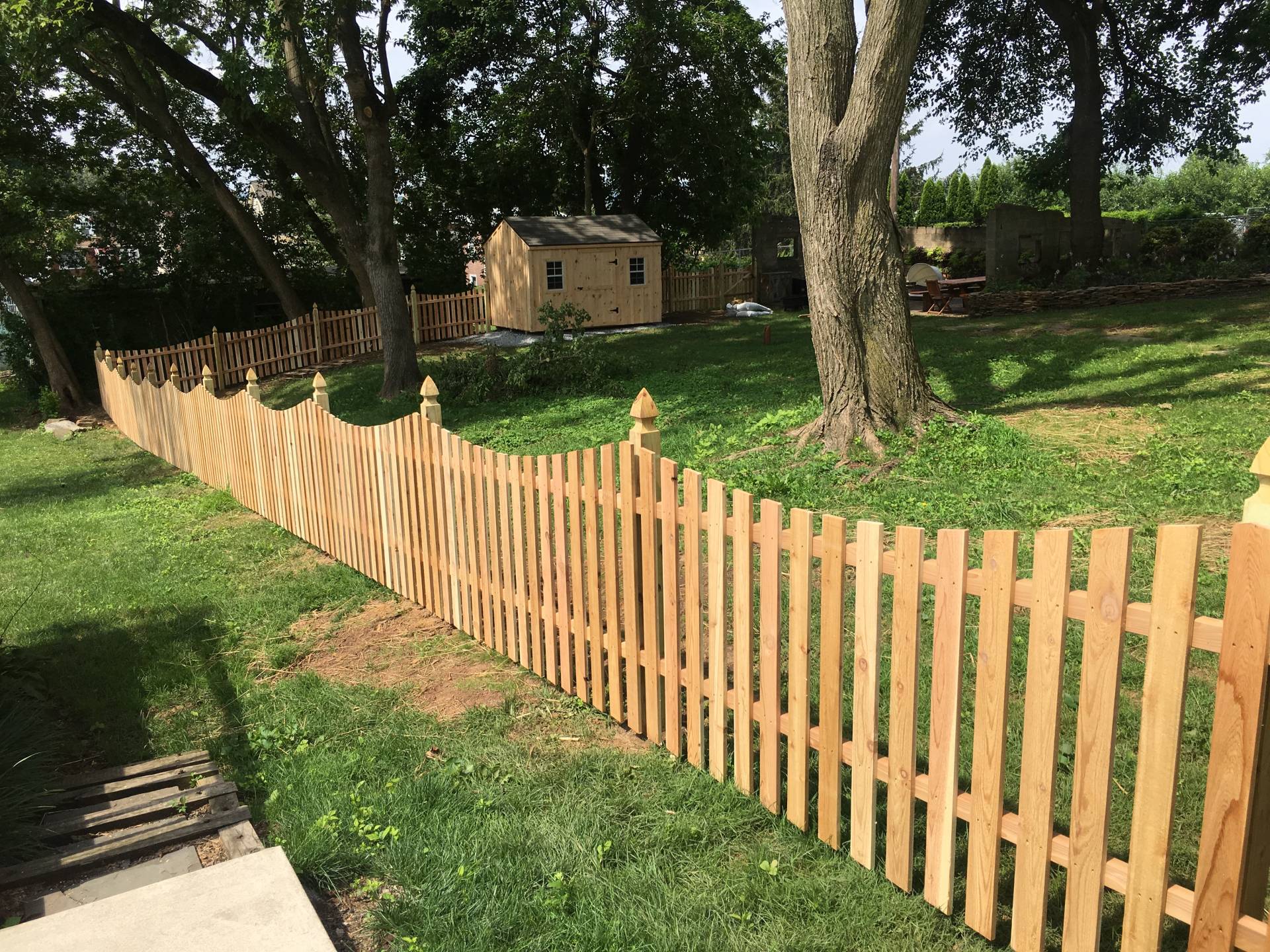 Red Cedar Concave Picket Fence with French Gothic Posts.