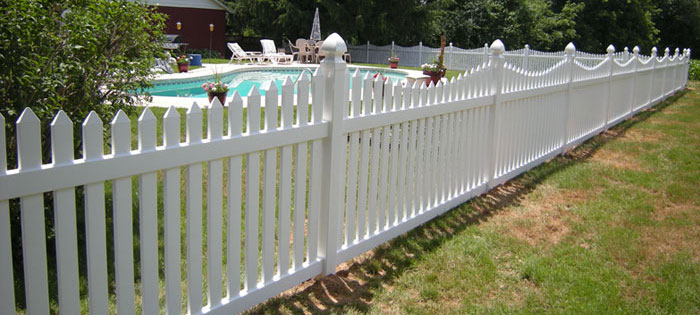 Pool fence made of picket white vinyl