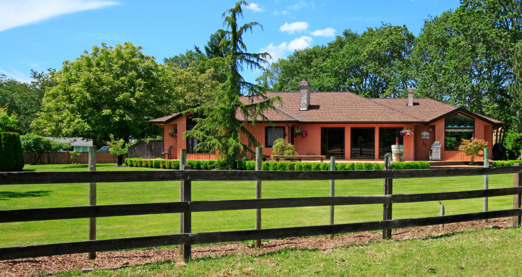 Farmhouse with new brown wooden fence