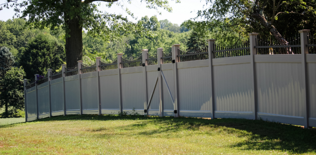 Tan vinyl privacy fenced yard