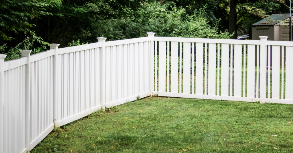 White vinyl picket fenced in backyard