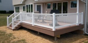 White vinyl deck railing with new tan deck