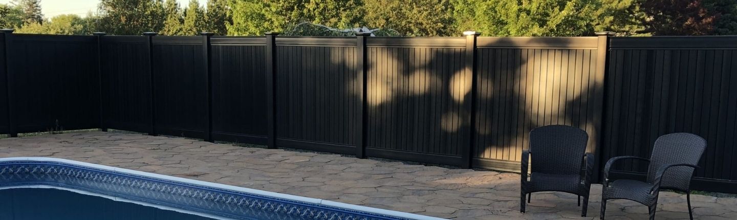 Black contemporary fence style by pool