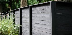 black horizontal wood fence ideas privacy in front of tree